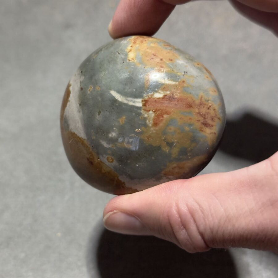 close-up of a polychrome jasper stone with vivid color variations